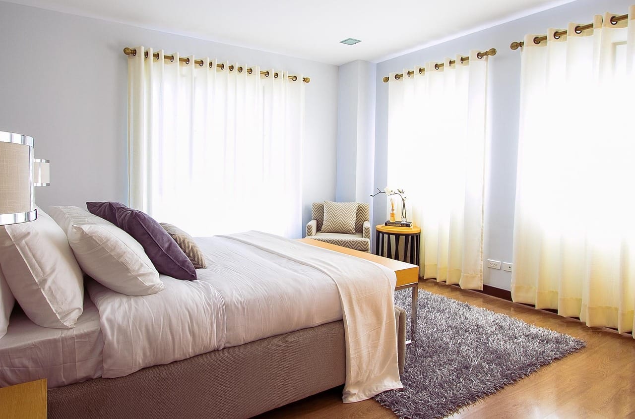 The bedroom upstairs: soft grey linen and very little else.