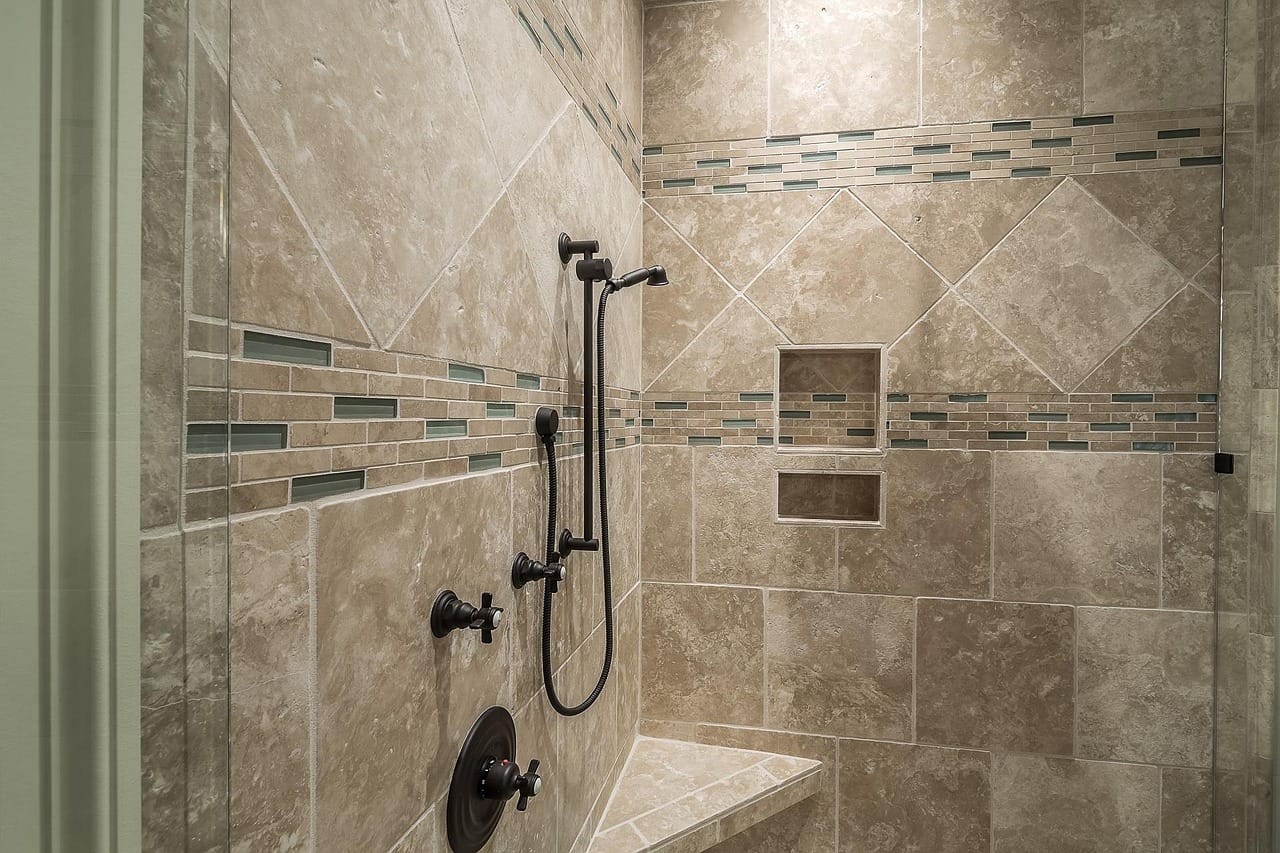 Large-format porcelain: fewer grout lines, calmer walls.