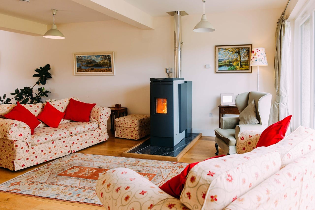 A wood stove at the centre of the room, with logs from their own trees.