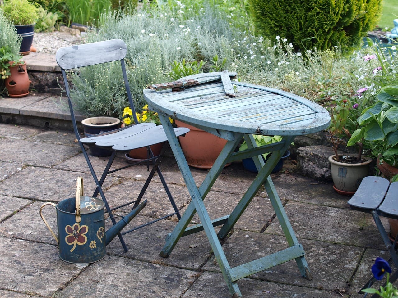 The finished patio, with two old chairs and a table from a car boot sale.