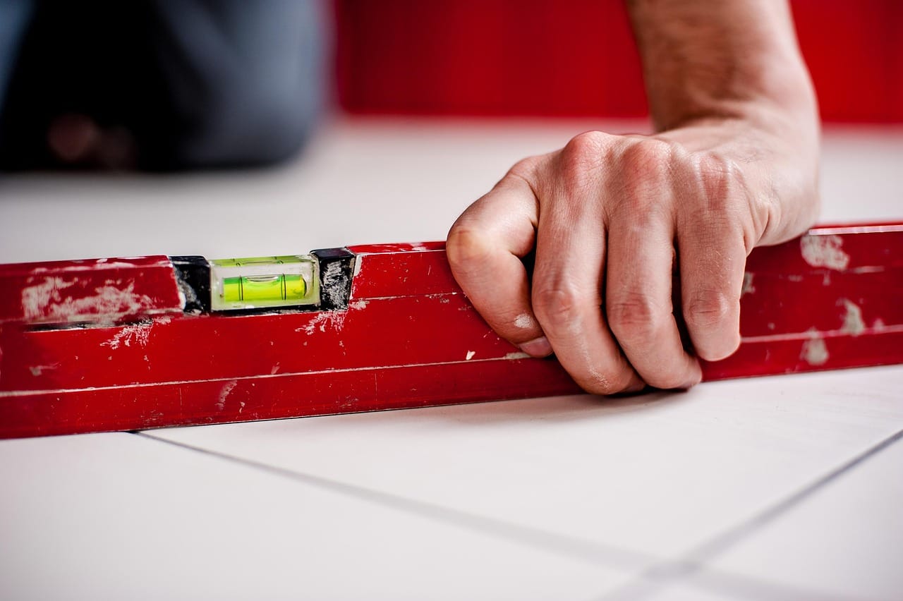 A spirit level on new tiles. Most repairs need only a few simple tools.