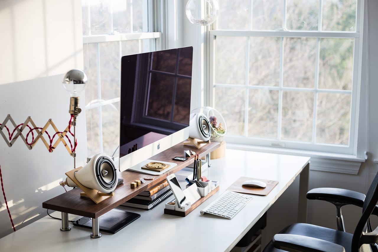 The desk, cleared for guests. The lamp swings back against the wall.