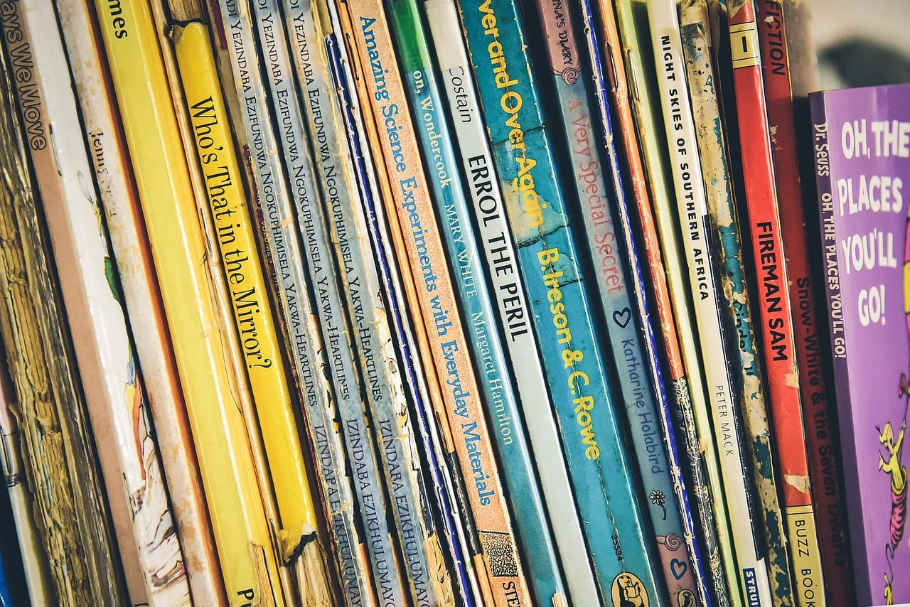Books facing out, at her height. She reads far more of them this way.