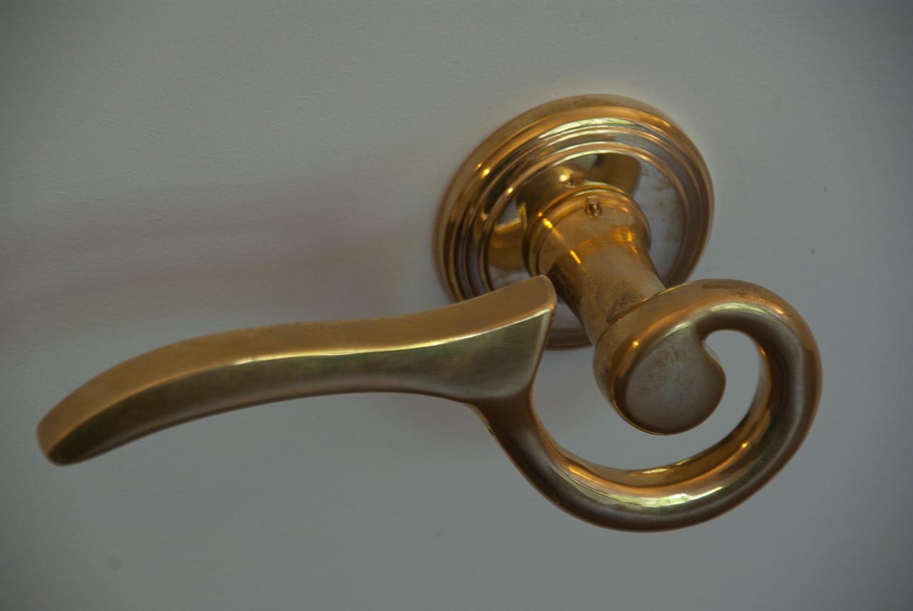 Solid brass handles, unlacquered, so they darken where hands touch them most.