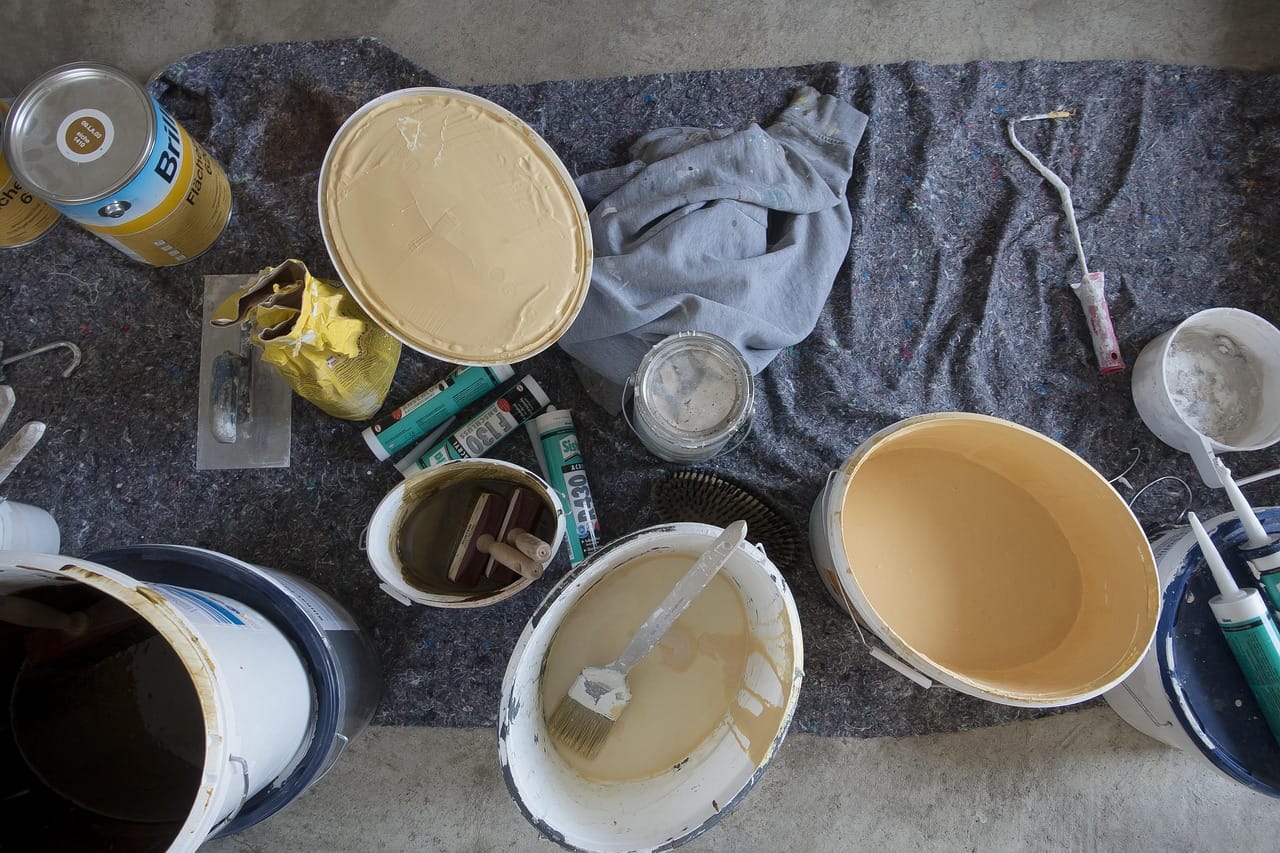 Short, crossing strokes with a wide brush. Work in patches about a metre square and keep a wet edge.