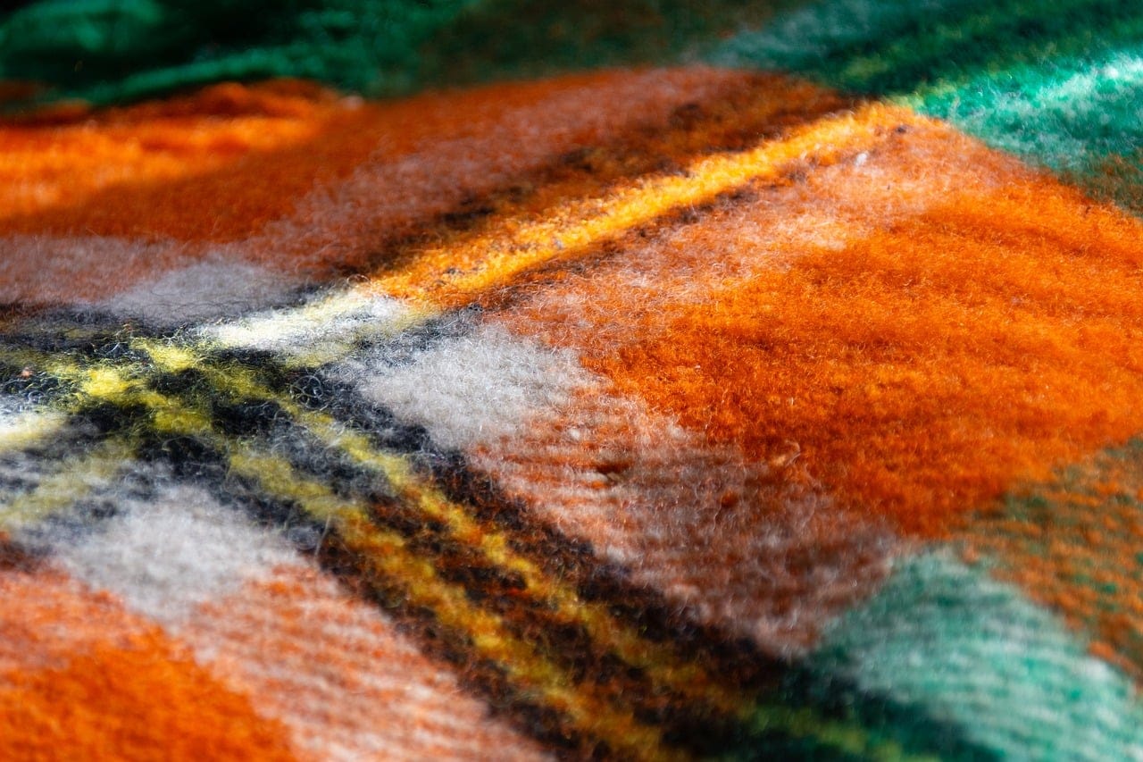 A heavy wool throw: the easiest way to make a room warmer in winter.